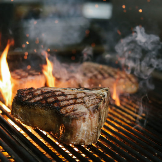 NY Strip grilling with flames