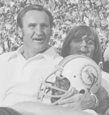 Don Shula hoisted by football player